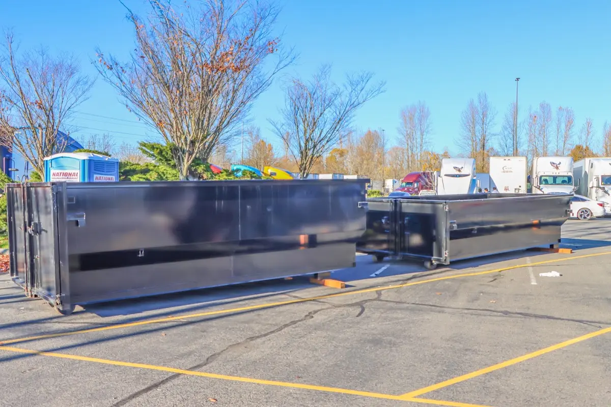Professional dumpster rental service with roll-off container on residential driveway in Terrytown